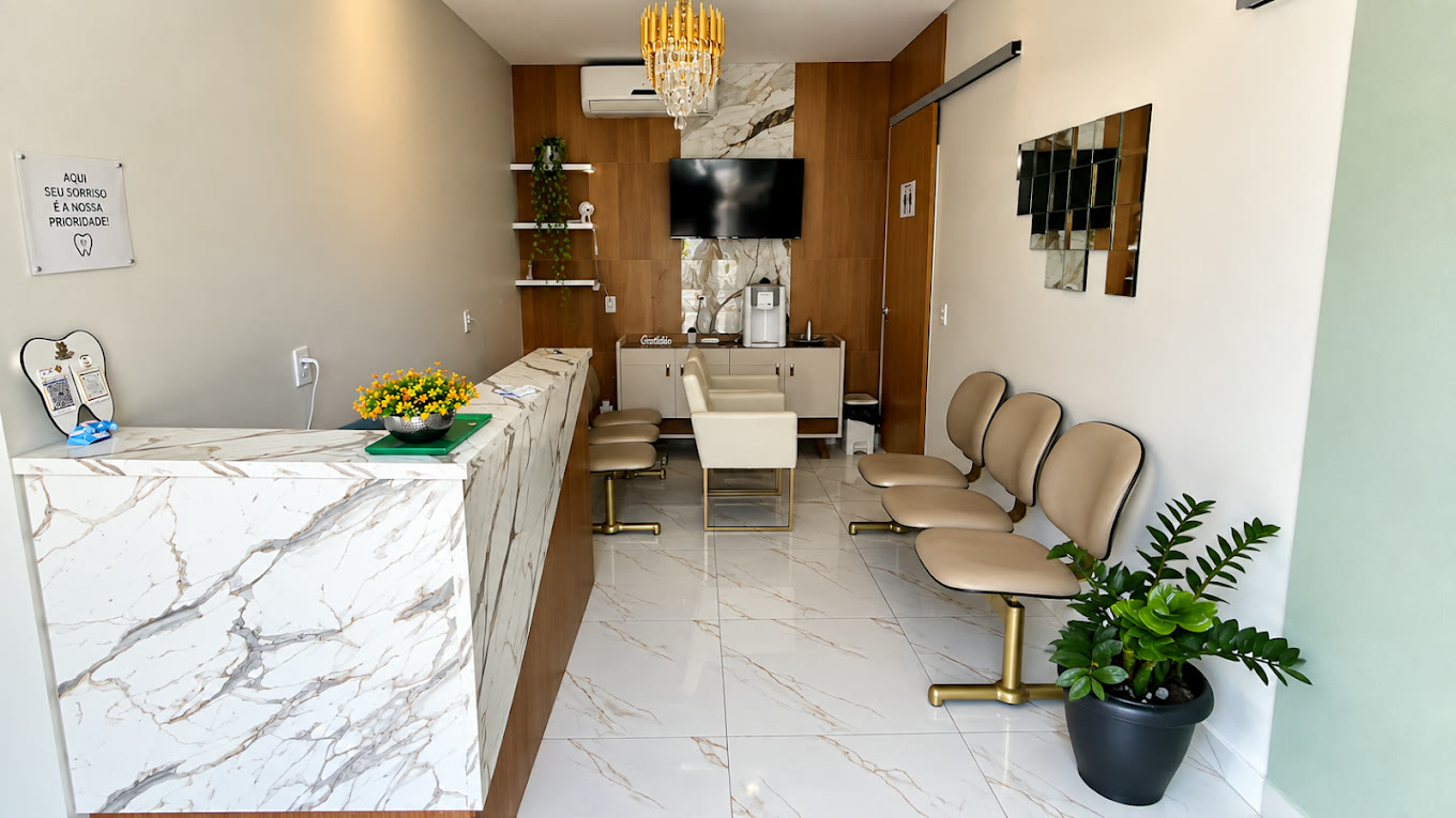 Recepção da Odonto Artty, com balcão de mármore e poltronas
